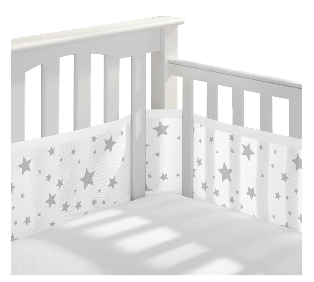 A breathable mesh crib liner in soft starlight print, covering the inside of a full-size crib with airy, protective 3mm mesh.